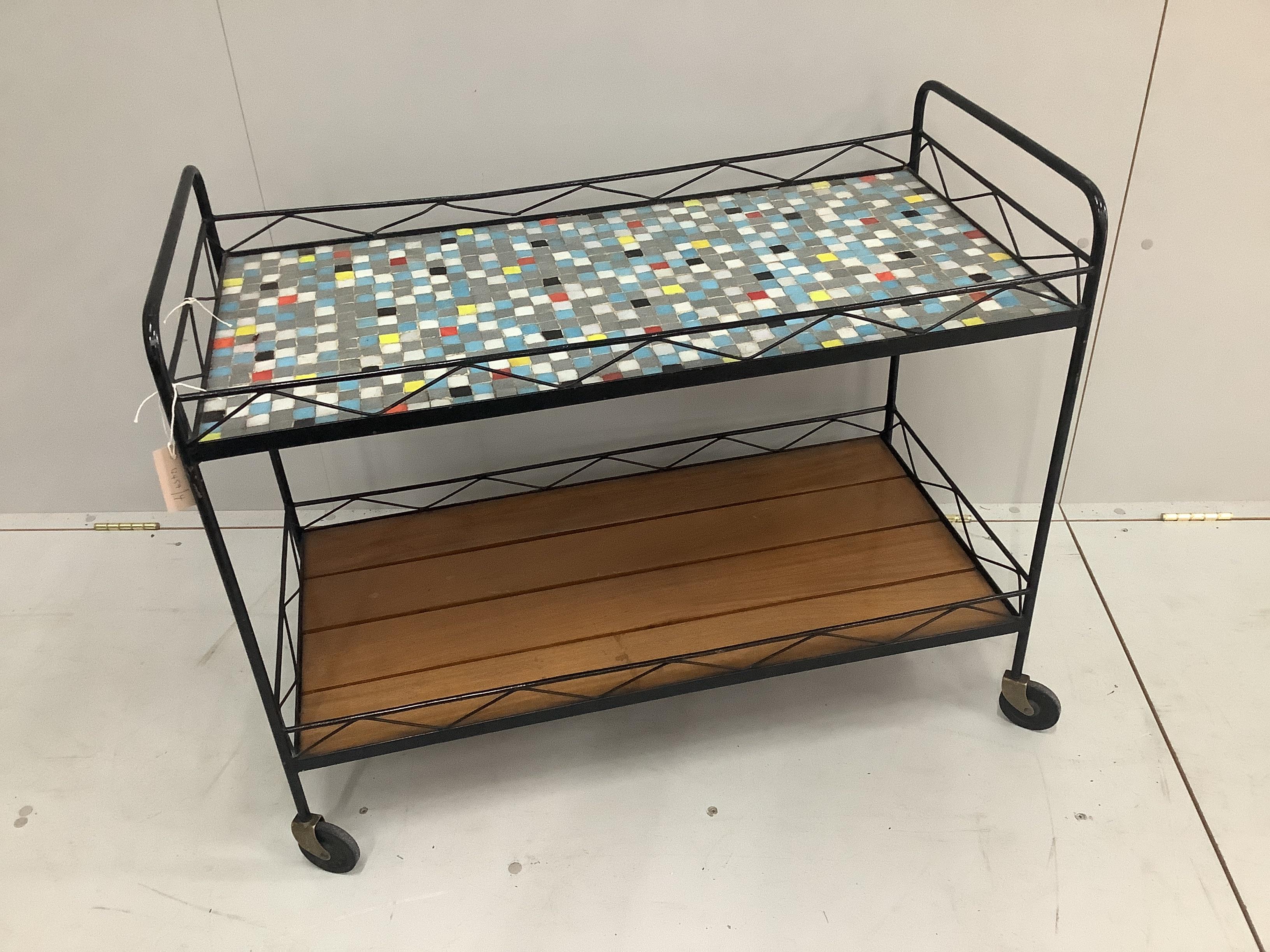 A 1960's tiled top and teak wrought iron two tier tea trolley, width 90cm, depth 43cm, height 72cm